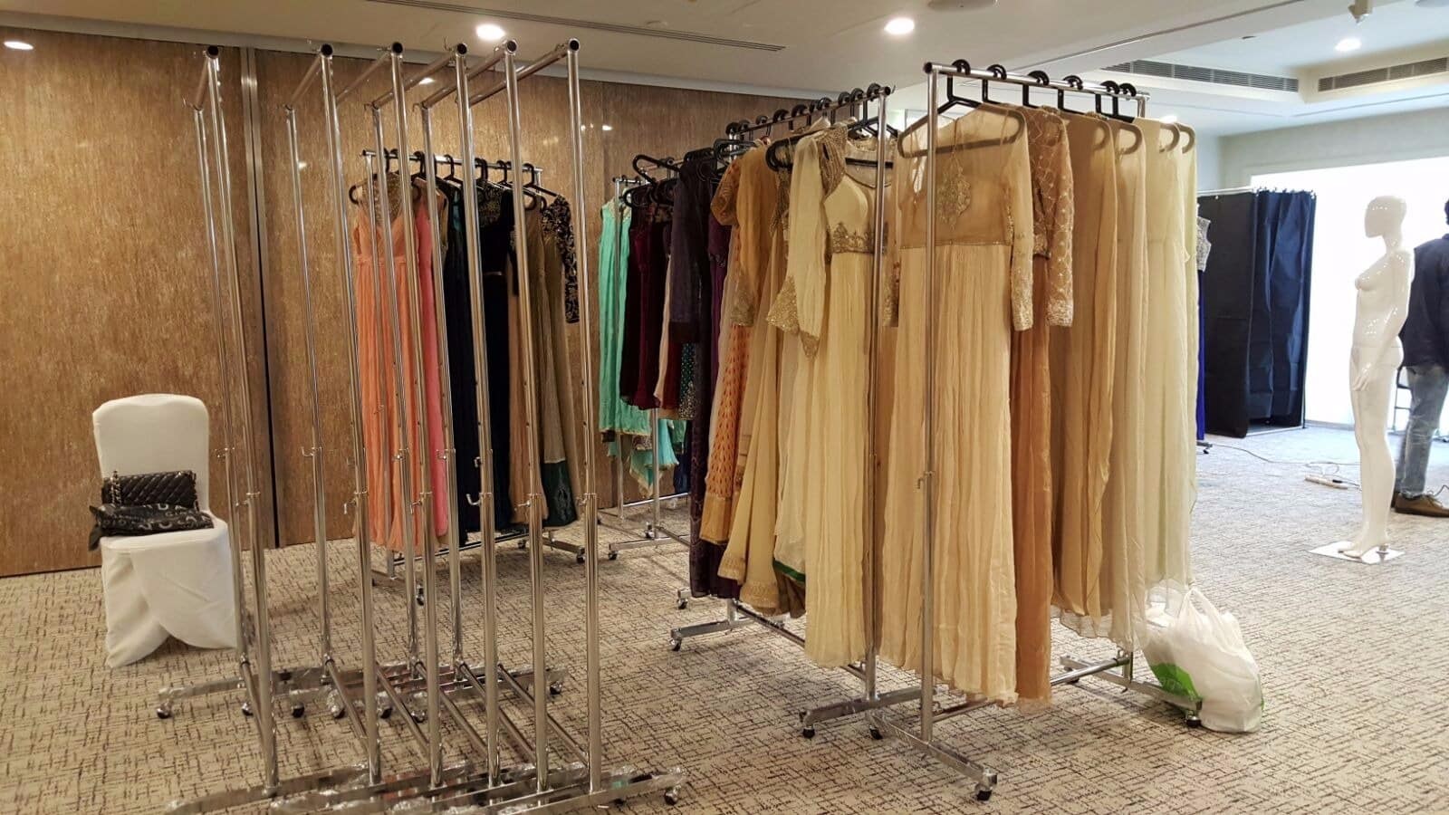 Clothes racks on wheels displaying garments