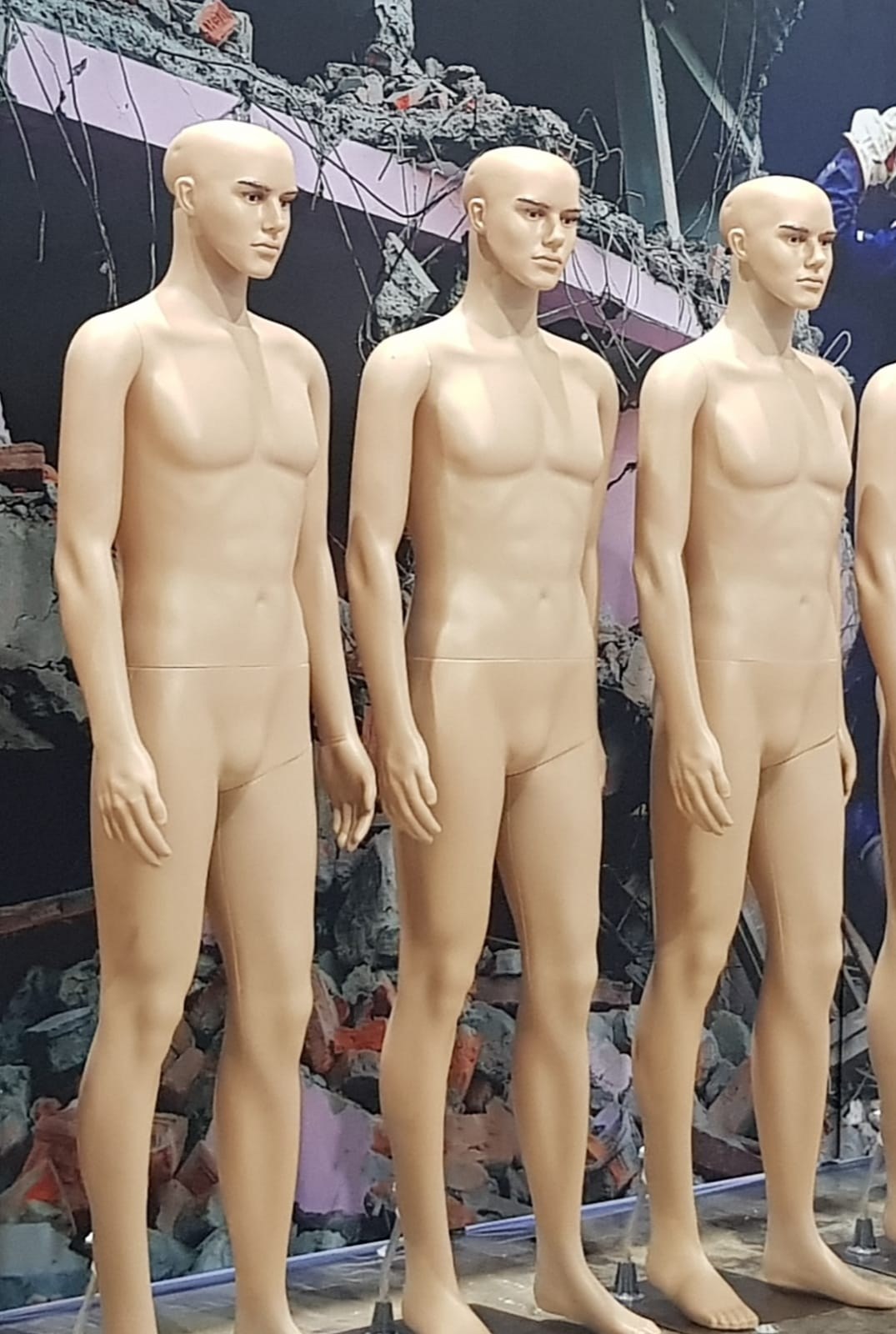 Skin-tone male full-body mannequins with facial features