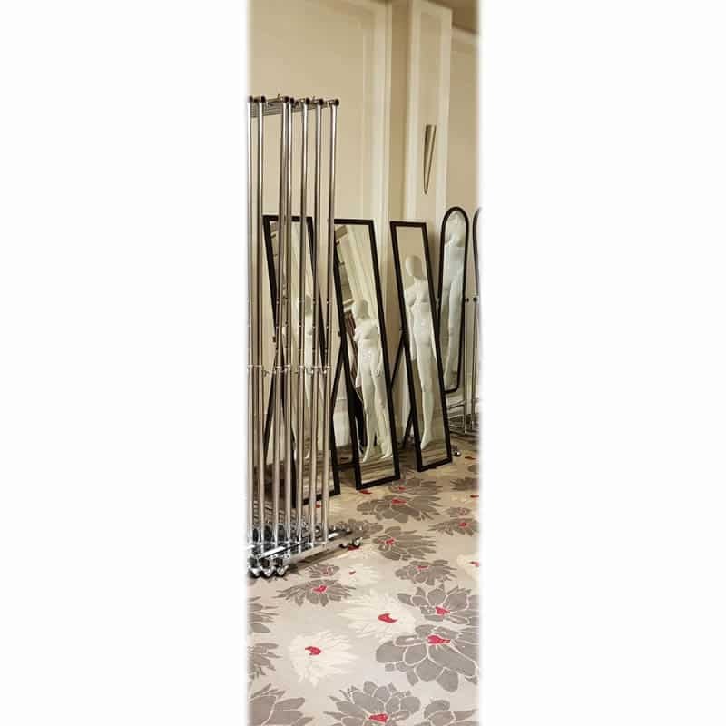 Freestanding full-length mirrors beside clothes racks